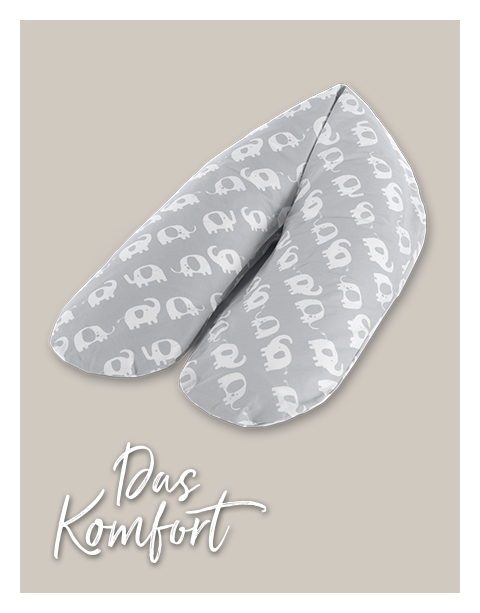 Ein graues Stillkissen mit weißen Elefantendesigns liegt auf einem einfarbigen Hintergrund. Der Text darunter lautet 